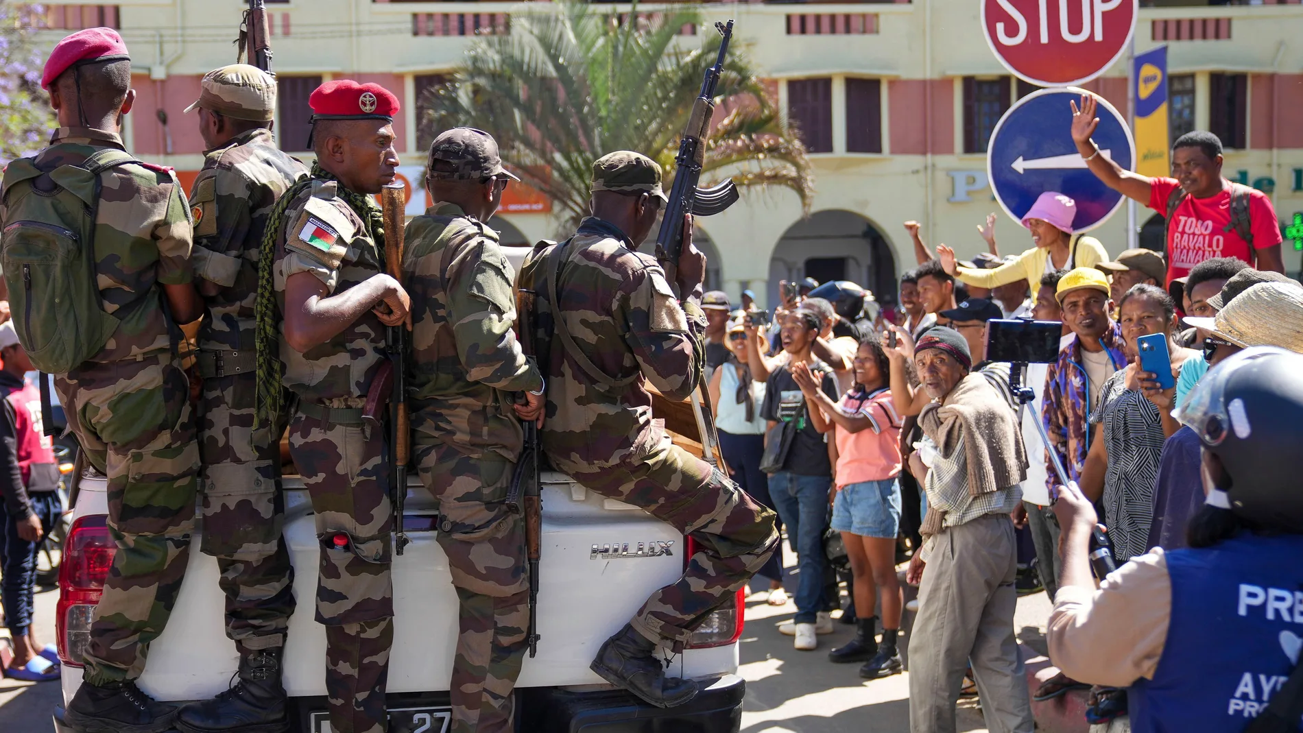 Soldiers are greeted by people gathering for a ceremony in tribute to demonstrators killed during recent anti-government protest in Antananarivo, Madagascar, Sunday, Oct. 12, 2025. (AP Photo/Mamyrael)