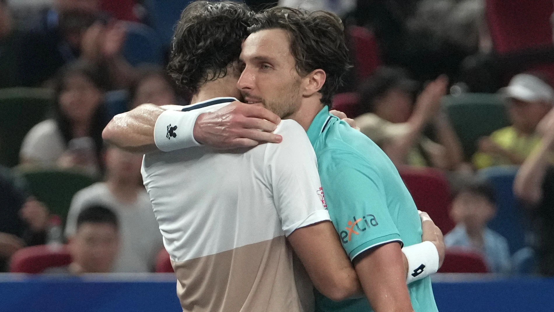 Valentin Vacherot of Monaco, left, embrace Arthur Rinderknech of France, at the net after he won the final of the Shanghai Masters tennis tournament at Qizhong Forest Sports City Tennis Center, in Shanghai, China, Sunday, Oct. 12, 2025. (AP Photo/Andy Wong)