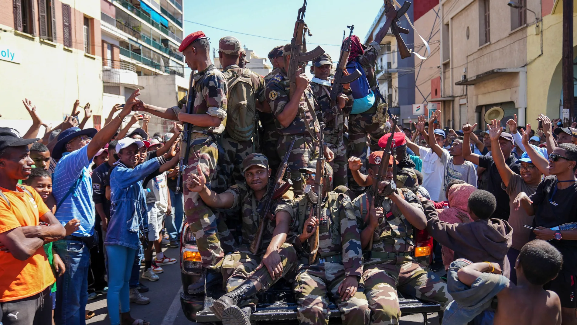 Soldiers are greeted by people gathering for a ceremony in tribute to demonstrators killed during recent anti-government protest in Antananarivo, Madagascar, Sunday, Oct. 12, 2025. (AP Photo/Mamyrael)