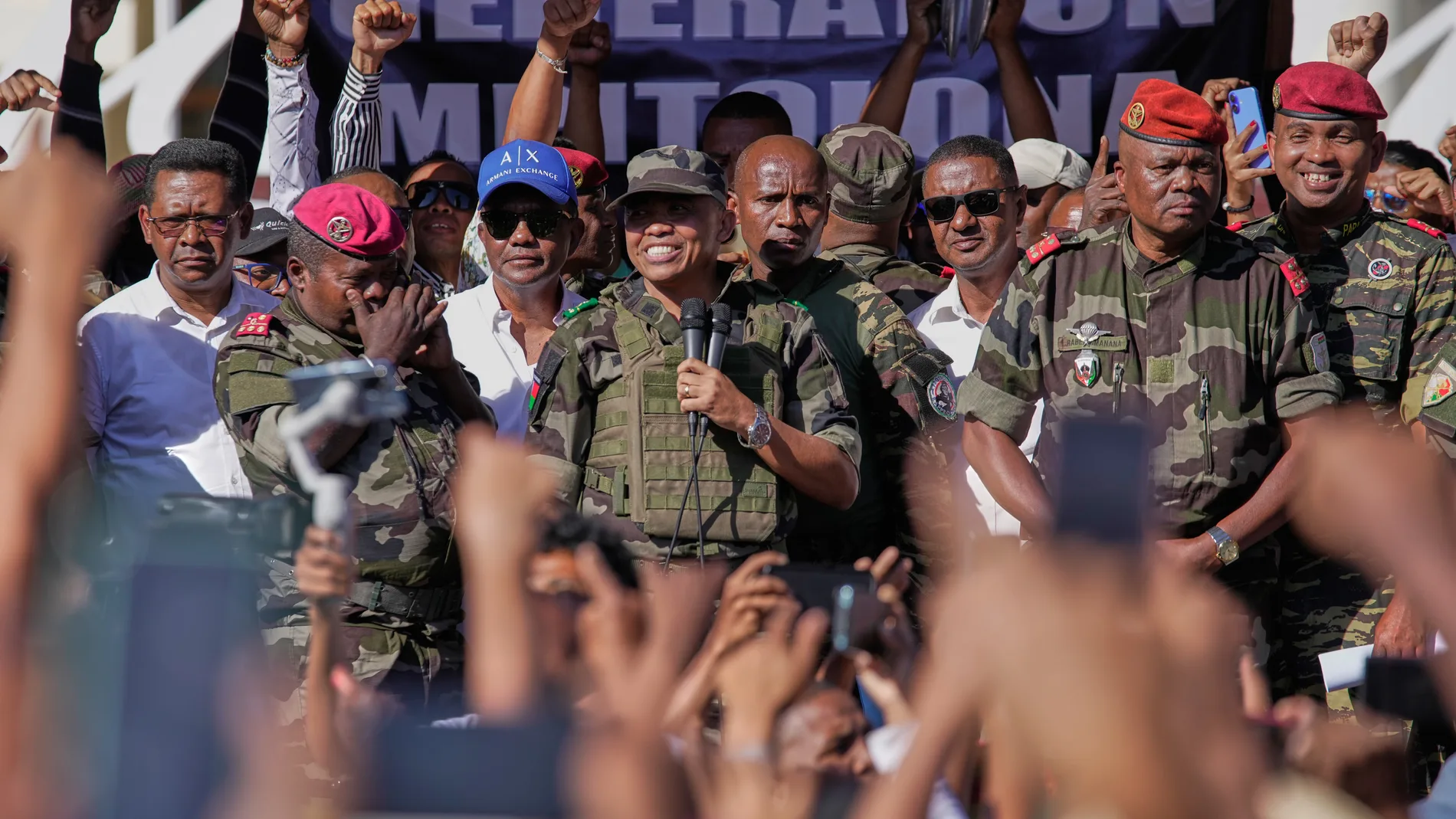 CAPSAT military unit commander Col. Michael Randrianirina announces to protesters that the armed forces are taking control of the country in Antananarivo, Madagascar, Tuesday, Oct. 14, 2025. (AP Photo/Brian Inganga)