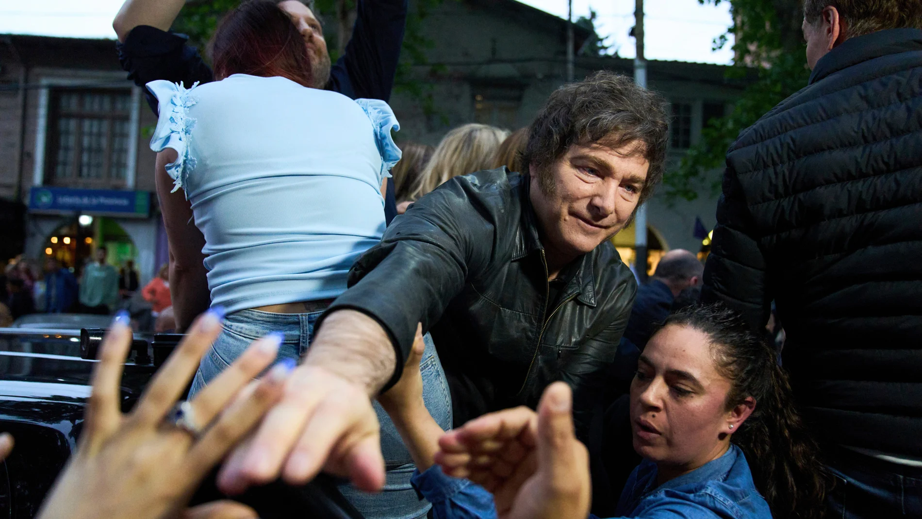 President Javier Milei greets supporters during a campaign rally ahead of mid-term elections, in Tres de Febrero, Buenos Aires province, Argentina, Friday, Oct. 17, 2025. (AP Photo/Rodrigo Abd)