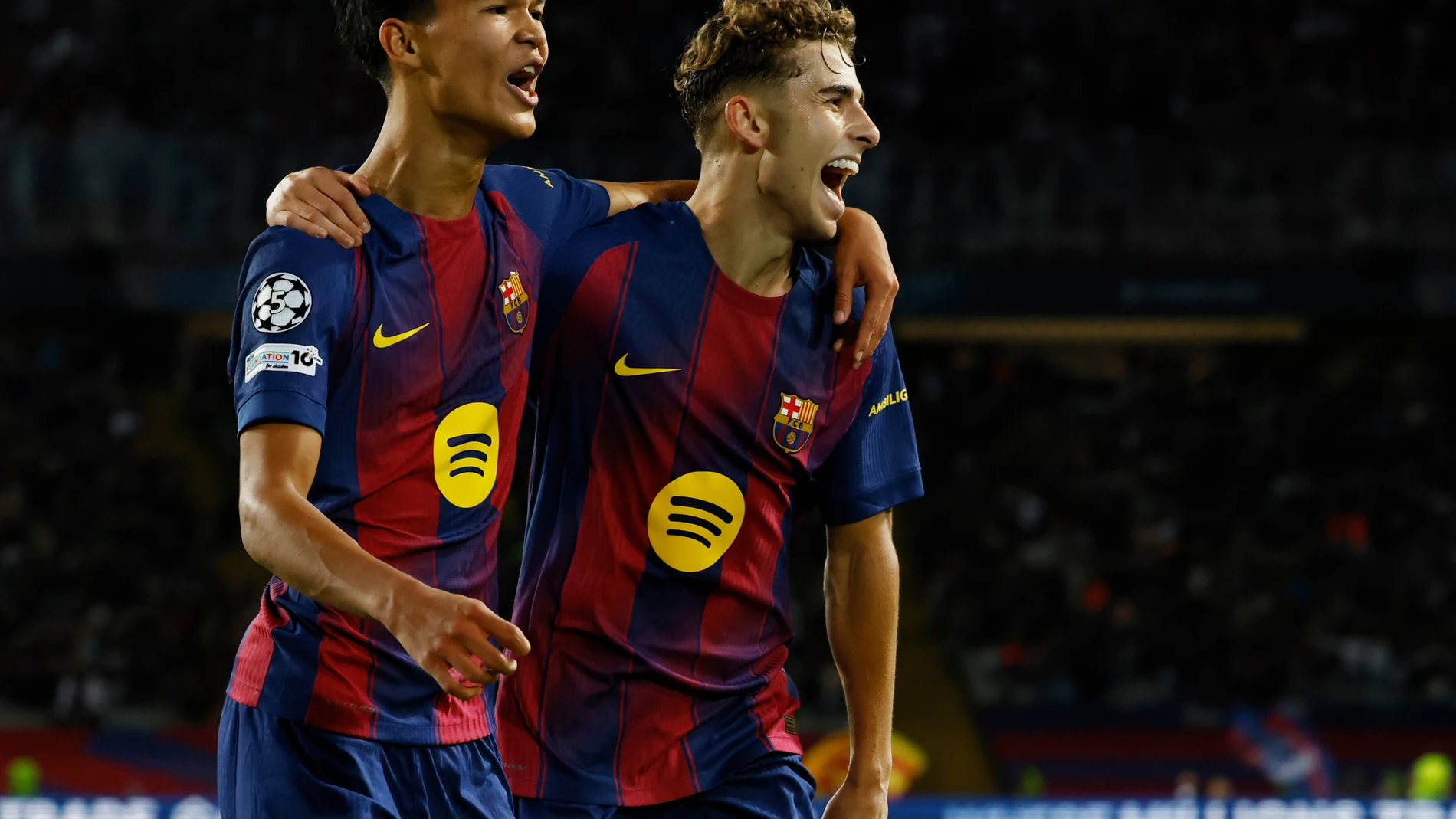 Barcelona's Fermin Lopez, right, celebrates with Dro Fernandez after scoring his side's second goal during the Champions League opening phase soccer match between Barcelona and Olympiacos in Barcelona, Spain, Tuesday, Oct. 21, 2025. (AP Photo/Joan Monfort)