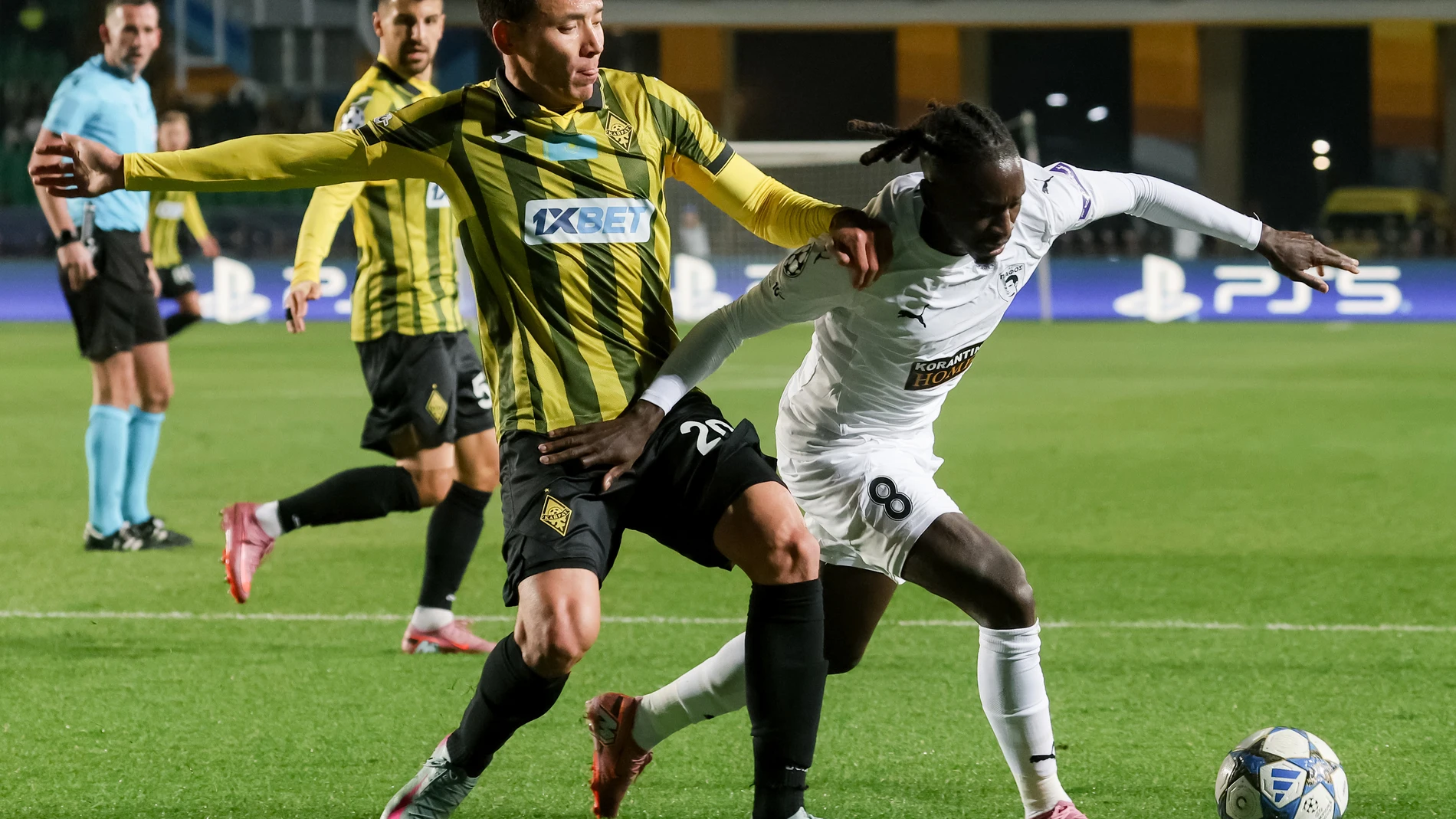 Kairat's Yerkin Tapalov, left, and Pafos' Quina fight for the ball during the Champions League opening phase soccer match between Kairat Almaty and Pafos FC in Almaty, Kazakhstan, Tuesday, Oct. 21, 2025. (AP Photo/Alikhan Sariyev)