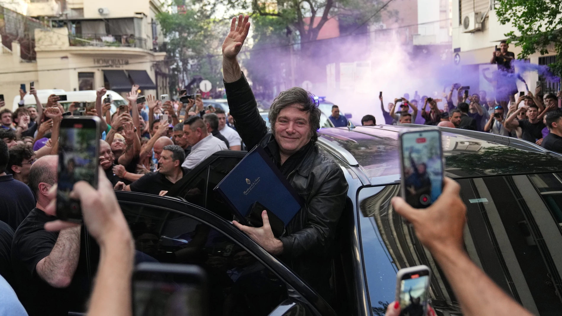 Argentine President Javier Milei waves to supporters upon arriving at a hotel in Rosario, Argentina, Thursday, Oct. 23, 2025. (AP Photo/Rodrigo Abd)