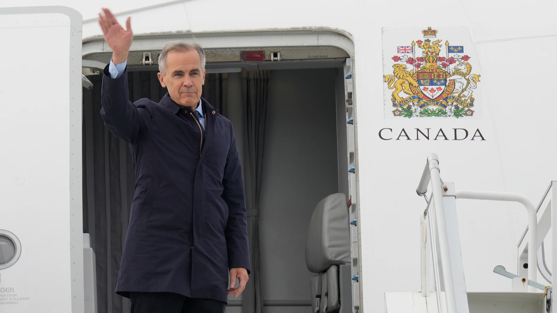 Canada Prime Minister Mark Carney boards a government plane in Ottawa on Friday Oct. 24, 2025. (Adrian Wyld/The Canadian Press via AP)