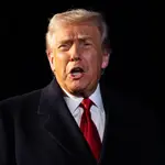 US President Donald Trump speaks with reporters while departing from the White House