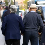 Una pareja de ancianos pasea cogidos de la mano por Madrid.