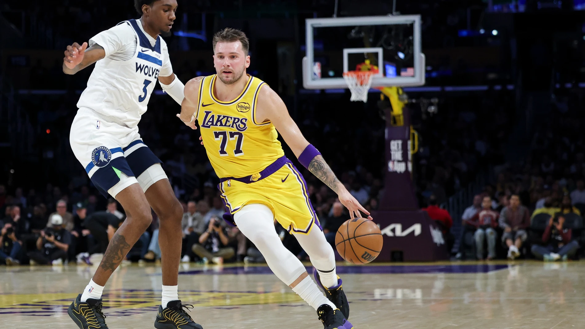 Los Angeles Lakers guard Luka Doncic (77) dribbles against the Minnesota Timberwolves forward Jaden McDaniels (3) during the first half of an NBA basketball game, Friday, Oct. 24, 2025, in Los Angeles. (AP Photo/Jessie Alcheh)