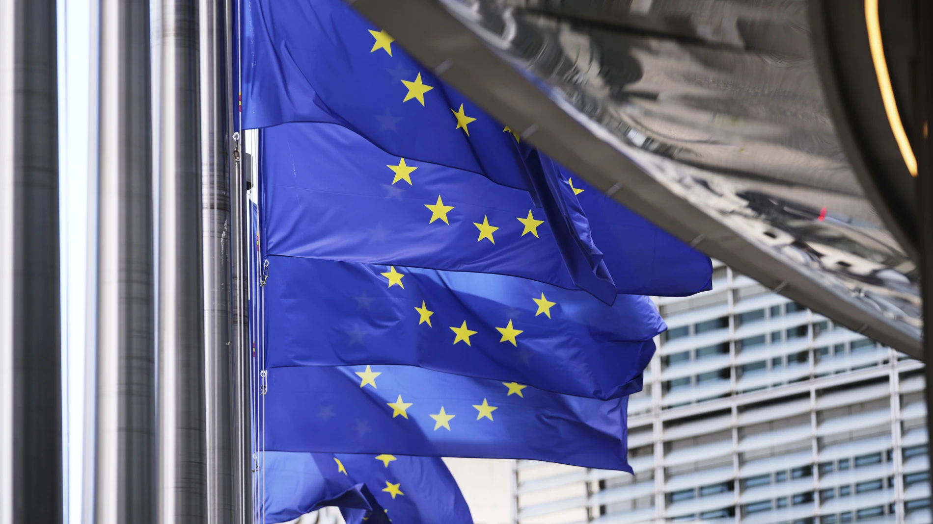 European Union flags flap in the wind outside EU headquarters in Brussels, Thursday, Aug. 21, 2025. (AP Photo/Virginia Mayo)