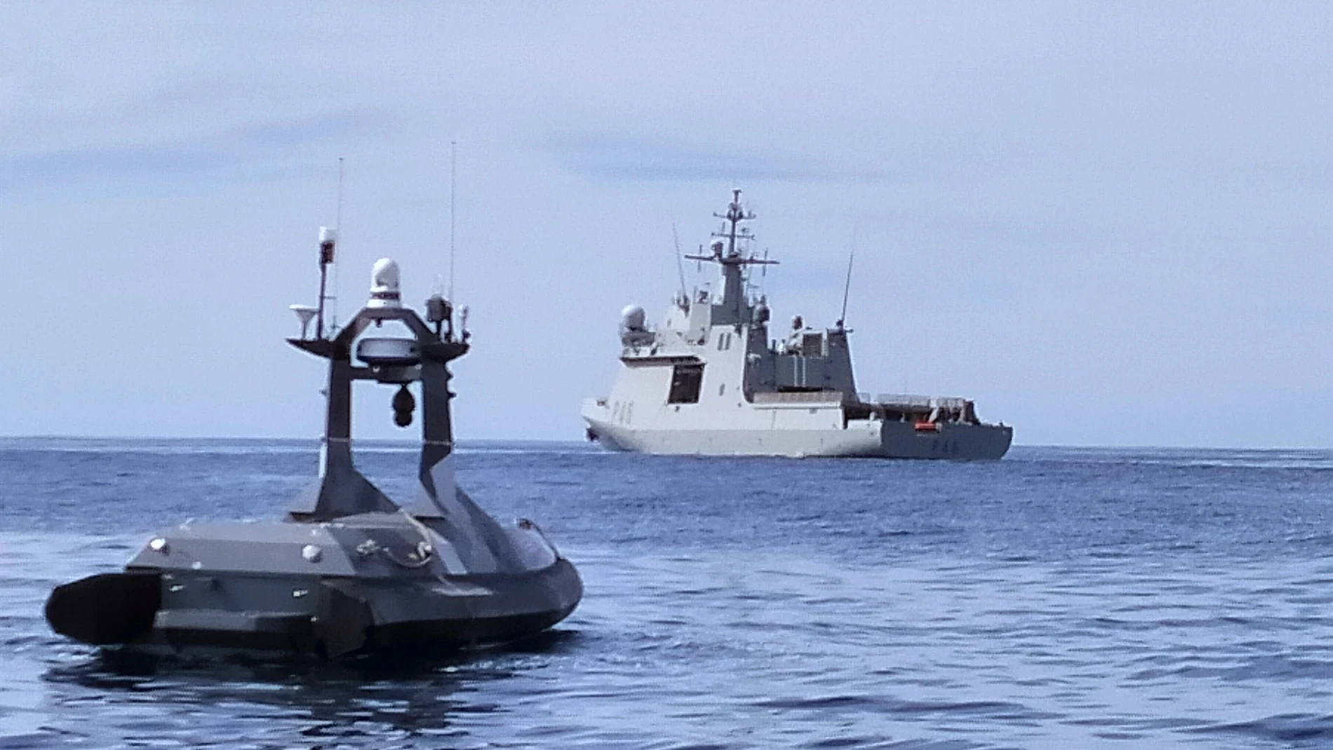 Dron marítimo cerca de un navío de guerra