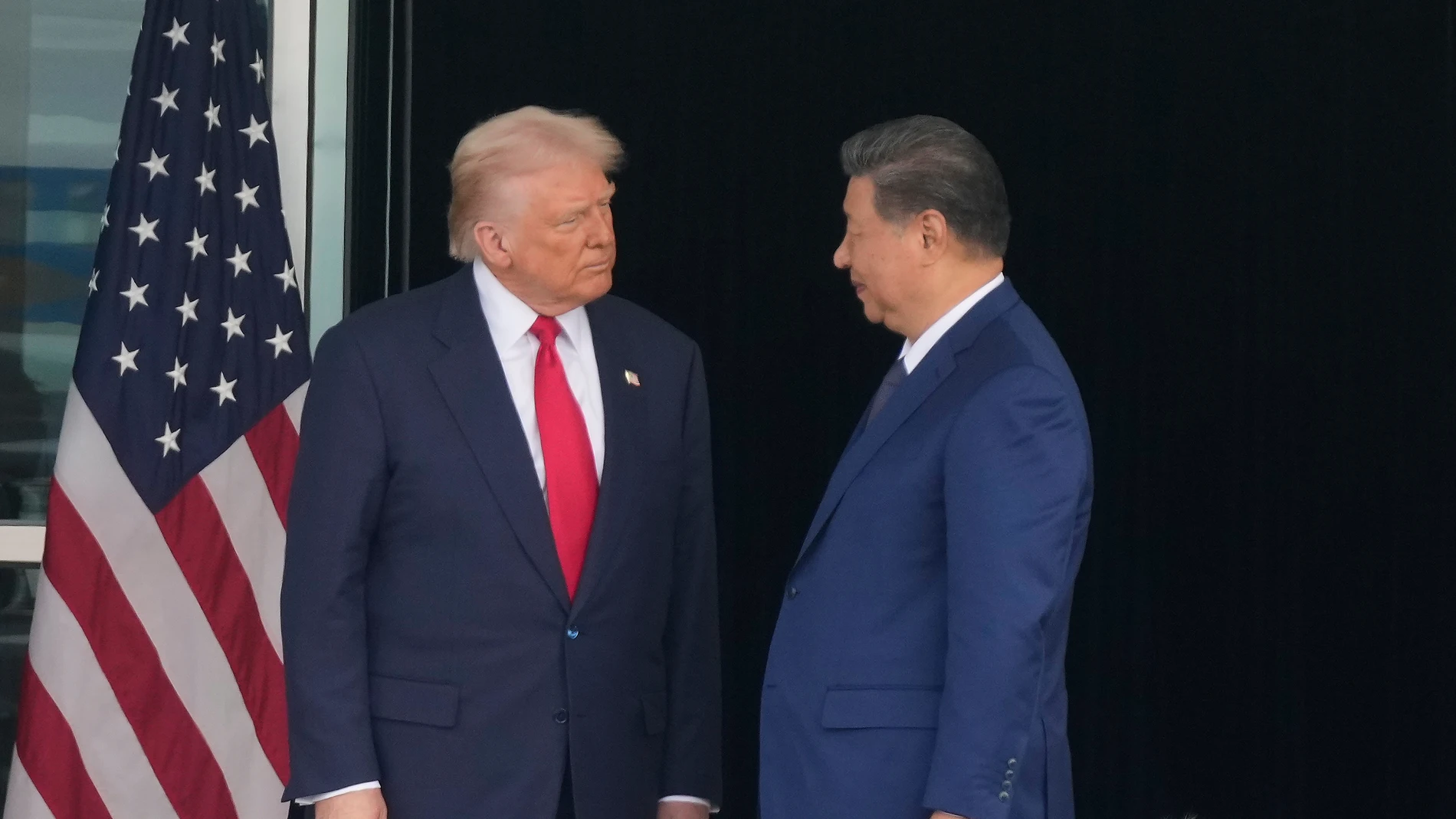 President Donald Trump, left, and Chinese President Xi Jinping, look at each other after their summit meeting at Gimhae International Airport Jinping in Busan, South Korea, Thursday, Oct. 30, 2025. (AP Photo/Mark Schiefelbein)
