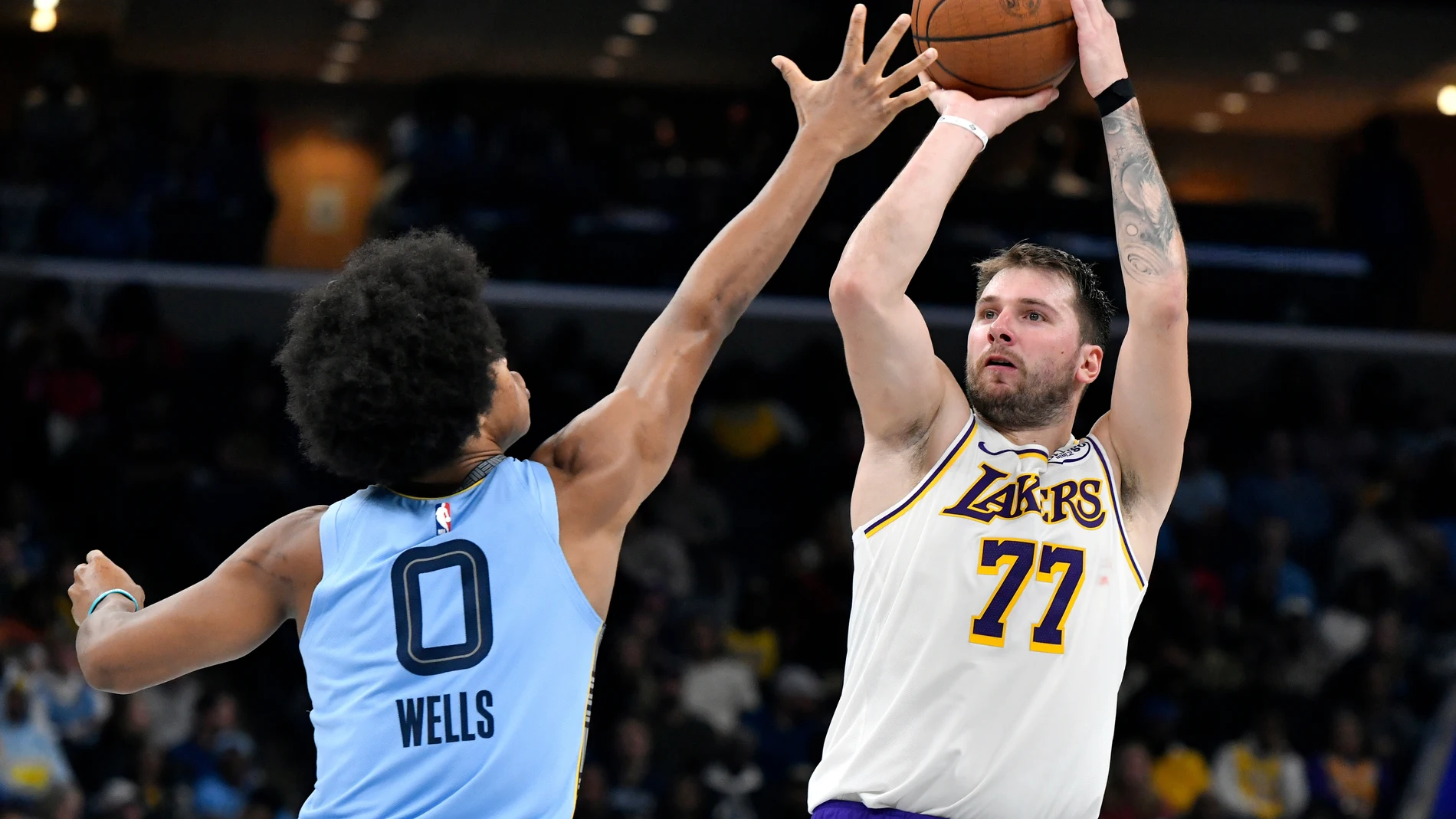 Los Angeles Lakers guard Luka Doncic (77) looks to shoot against Memphis Grizzlies forward Jaylen Wells (0) in the second half of an NBA Cup basketball game Friday, Oct. 31, 2025, in Memphis, Tenn. (AP Photo/Brandon Dill)