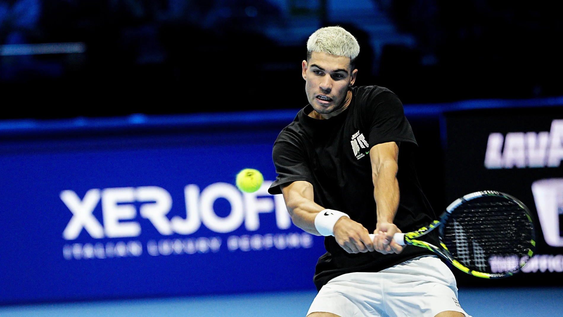 Carlos Alcaraz plays a backhand against Jannik Sinner as they practice on the central court of the Inalpi Arena, where the ATP Finals will begin on Sunday, in Turin, Italy, Friday, Nov. 7, 2025. (Marco Alpozzi/LaPresse via AP)