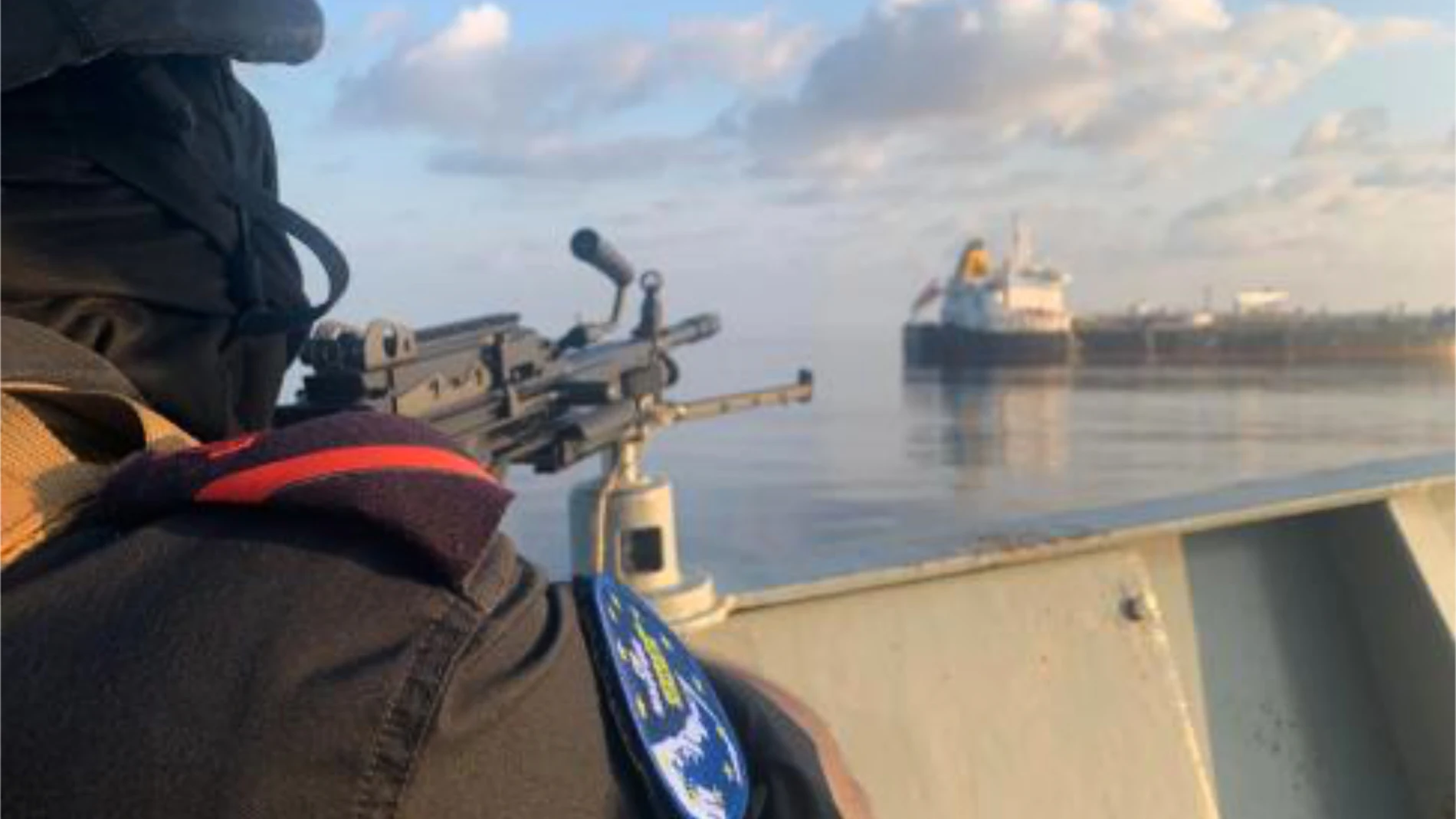 A member of the European Union's Operation Atalanta mans a machine gun aboard the ESPS Victoria while watching the Hellas Aphrodite off the coast of Somalia in the Arabian Sea on Friday, Nov. 7, 2025. (European Union's Operation Atalanta via AP)