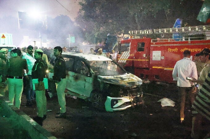 Indian police personnel inspect the scene of a blast near the red fort in New Delhi