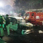 Indian police personnel inspect the scene of a blast near the red fort in New Delhi