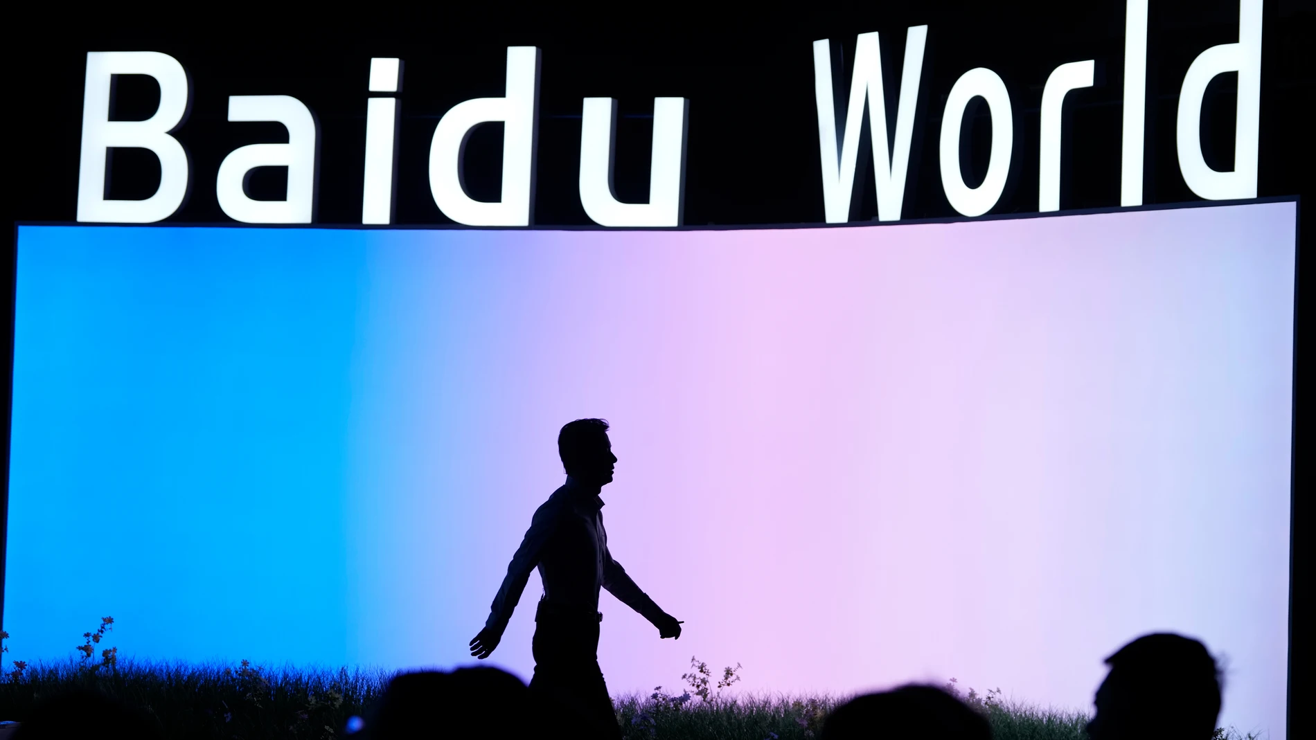 Robin Li, co-founder of Chinese search giant Baidu, is silhouetted as he attends the Baidu World conference in Beijing, China, Thursday, Nov. 13, 2025. (AP Photo/Ng Han Guan)