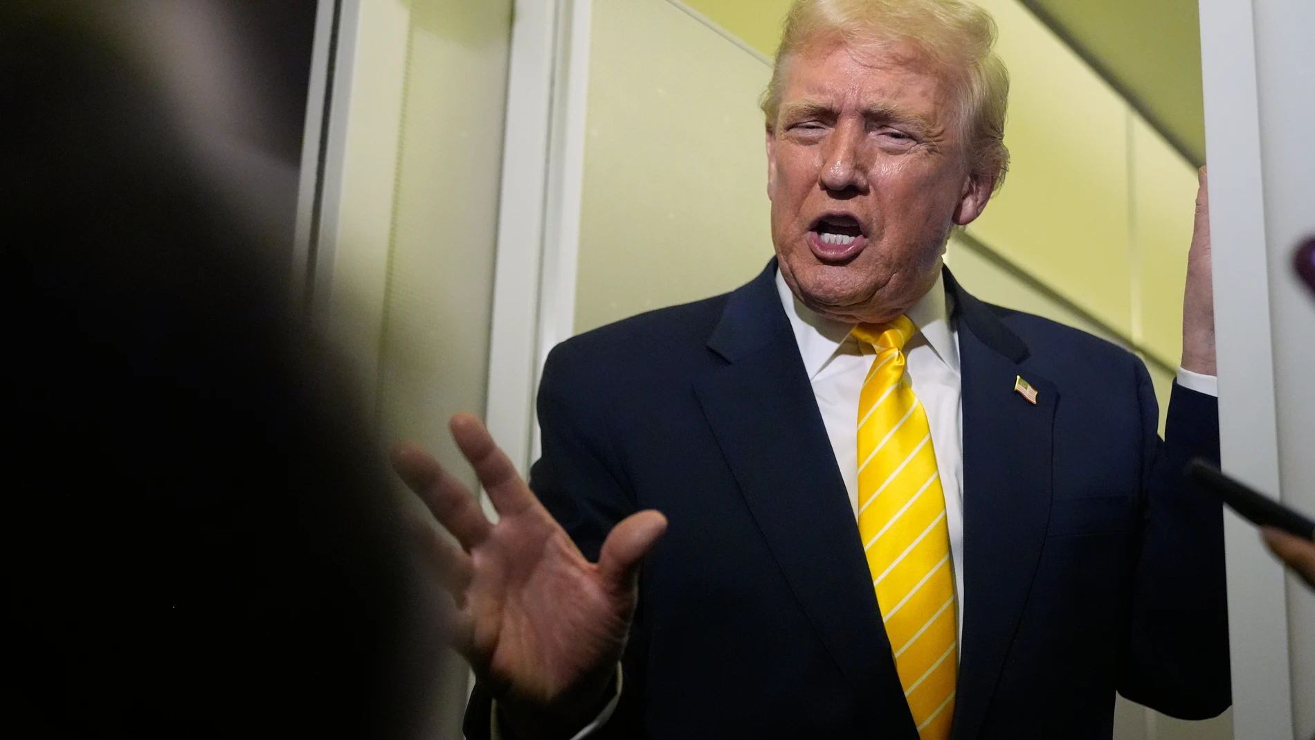 President Donald Trump speaks to reporters on Air Force One on his way to his Mar-a-Lago estate in Palm Beach, Fla., Friday, Nov. 14, 2025. (AP Photo/Manuel Balce Ceneta)