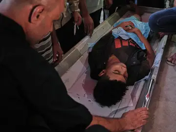 Israel Palestinians Gaza Relatives mourn over the body of a Palestinian killed in Israeli strikes on the Gaza Strip at Al-Aqsa Hospital in Deir al-Balah, Saturday, Nov. 22, 2025. (AP Photo/Abdel Kareem Hana)