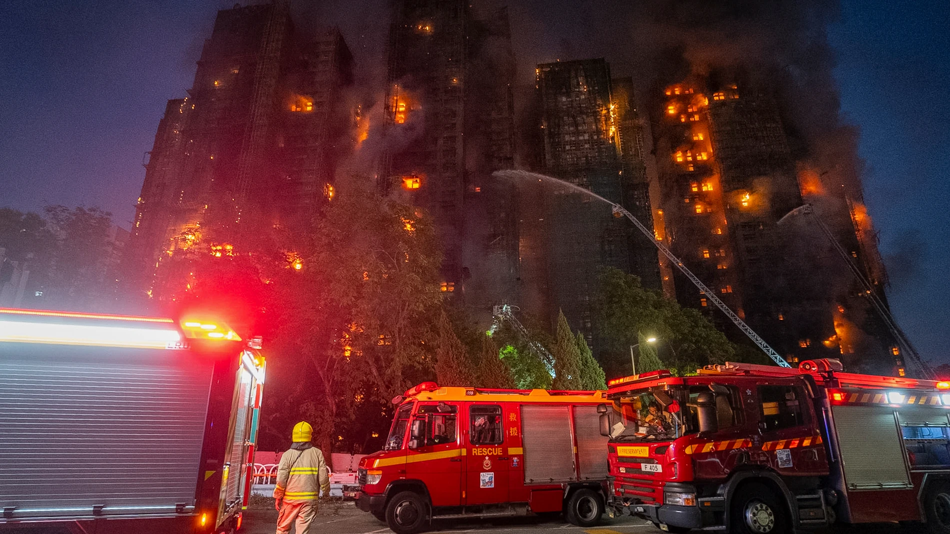 Firefighters work to extinguish a fire which broke out at Wang Fuk Court, a residential estate in the Tai Po district of Hong Kong's New Territories, Wednesday, Nov. 26 2025. (AP Photo/Chan Long Hei)