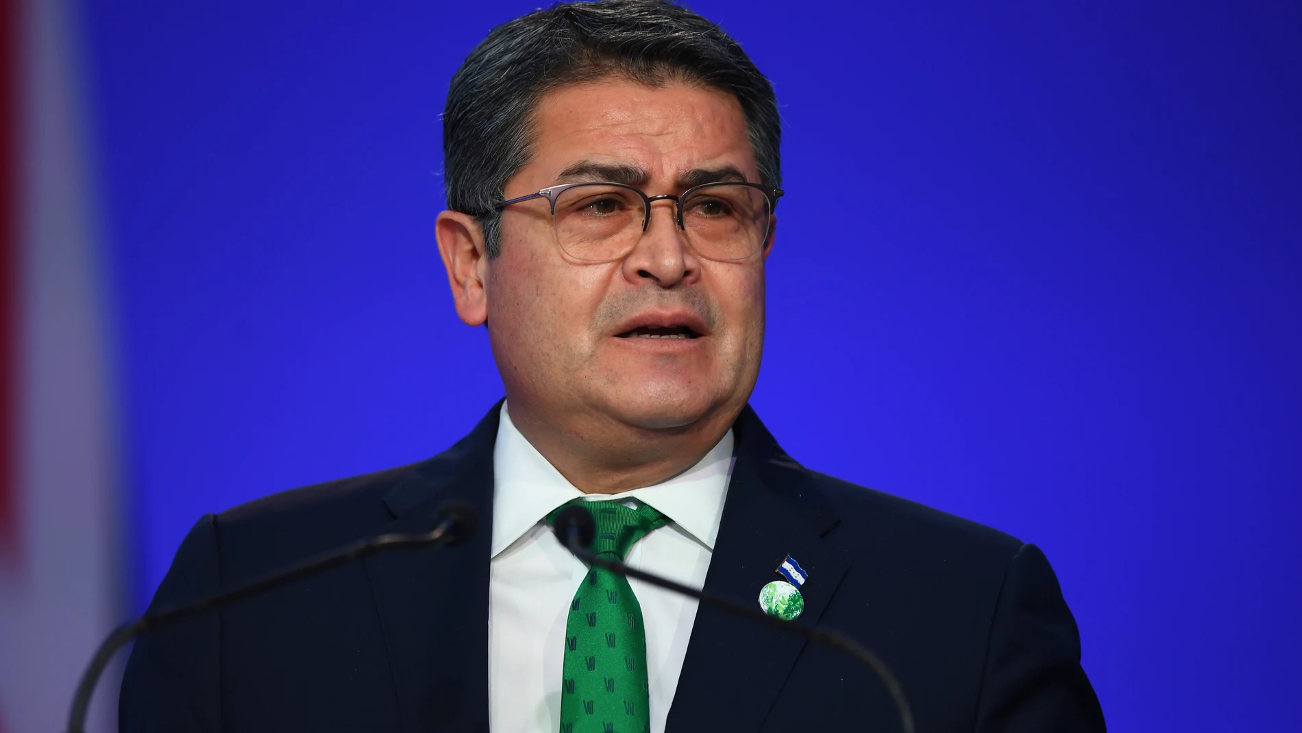 FILE - Honduras' President Juan Orlando Hernandez speaks during the opening ceremony of the UN Climate Change Conference COP26 in Glasgow, Scotland, Monday Nov. 1, 2021. Andy Buchanan/Pool via AP, File)