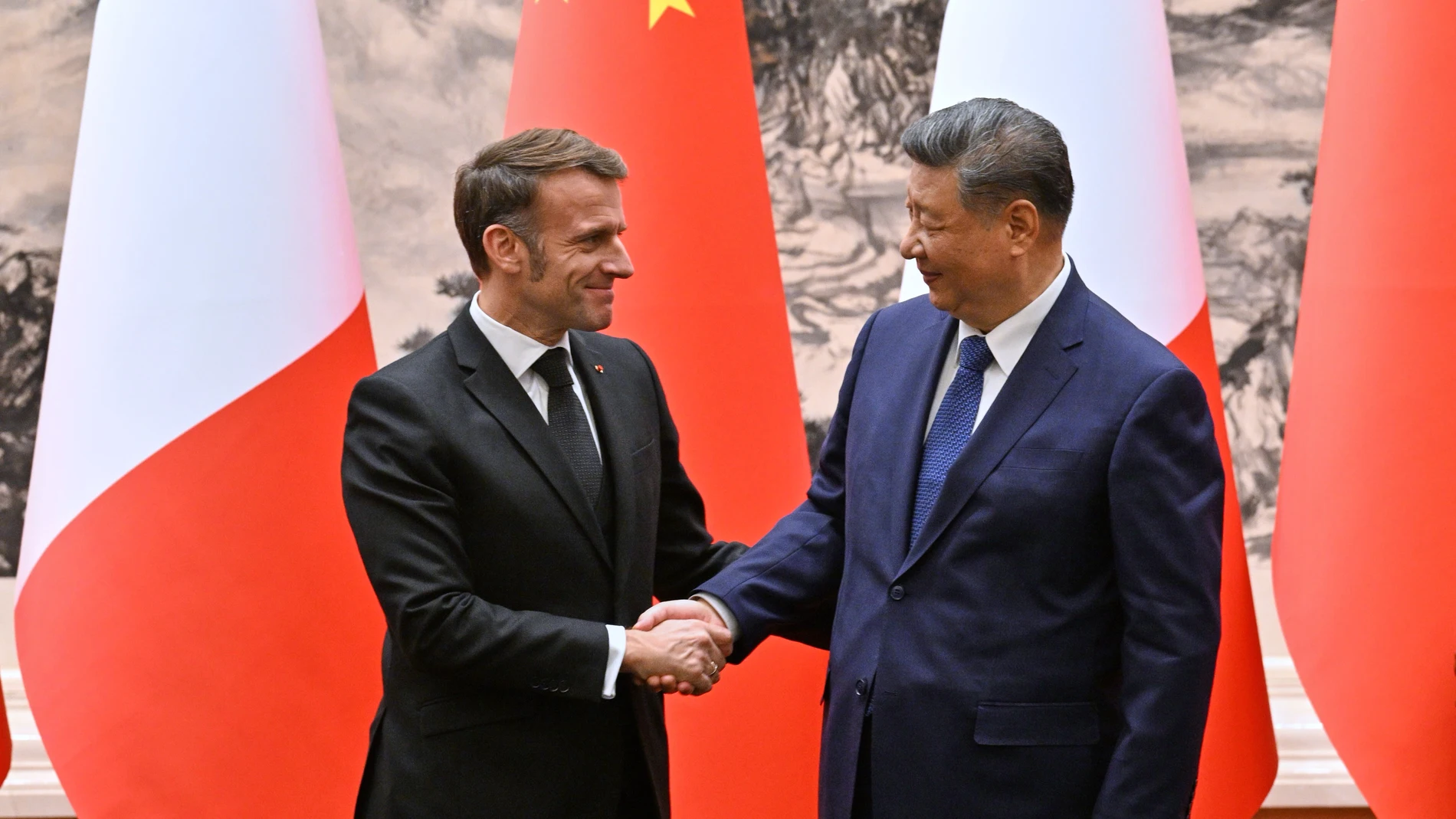 France's President Emmanuel Macron, left, and China's President Xi Jinping, right, shake hands after a joint press conference at the Great Hall of the People in Beijing Thursday, Dec. 4, 2025. (Adek Berry/Pool Photo via AP)