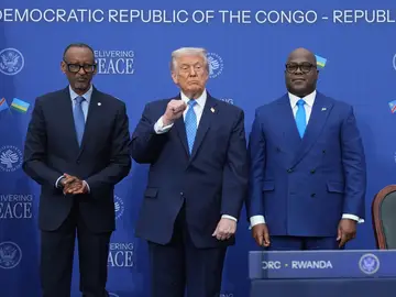 Trump President Donald Trump stands with Rwanda's President Paul Kagame and Democratic Republic of Congo President Felix-Antoine Tshisekedi at the Donald J. Trump Institute of Peace, Thursday, Dec. 4, 2025, in Washington. (AP Photo/Evan Vucci)