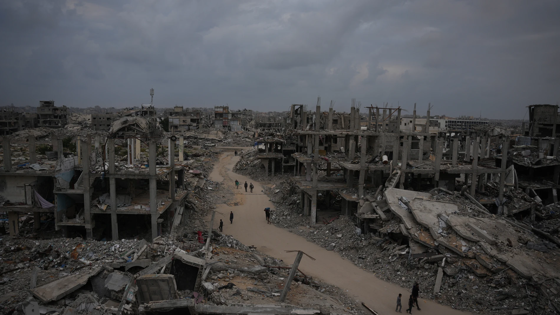 Palestinians walk on a street in Jabaliya, northern Gaza Strip, Saturday, Dec. 6, 2025. (AP Photo/Abdel Kareem Hana)