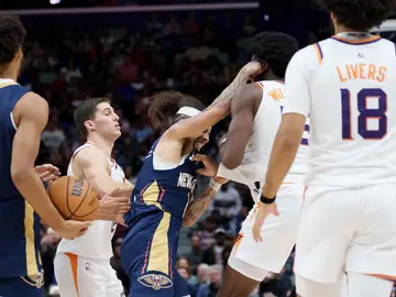 Suns Pelicans Basketball New Orleans Pelicans guard Jose Alvarado, left, and Phoenix Suns center Mark Williams (15) get into a scrum during the third quarter before both were ejected during an NBA basketball game in New Orleans, Saturday, Dec. 27, 2025. (AP Photo/Matthew Hinton)