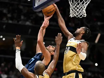 Grizzlies Wizards Basketball Washington Wizards center Alex Sarr (20) blocks a shot by Memphis Grizzlies forward Santi Aldama, upper left, during the second half of an NBA basketball game, Sunday, Dec. 28, 2025, in Washington. (AP Photo/John McDonnell)