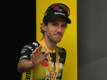 FILE - Stage winner Britain's Simon Yates celebrates on the podium after the tenth stage of the Tour de France cycling race over 165.3 kilometers (102.7 miles) with start in Ennezat and finish in Le Mont-Dore Puy de Sancy, France, Monday, July 14, 2025. (AP Photo/Thibault Camus, File)