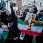 Manifestantes queman la bandera iraní en apoyo a las protestas en Francia