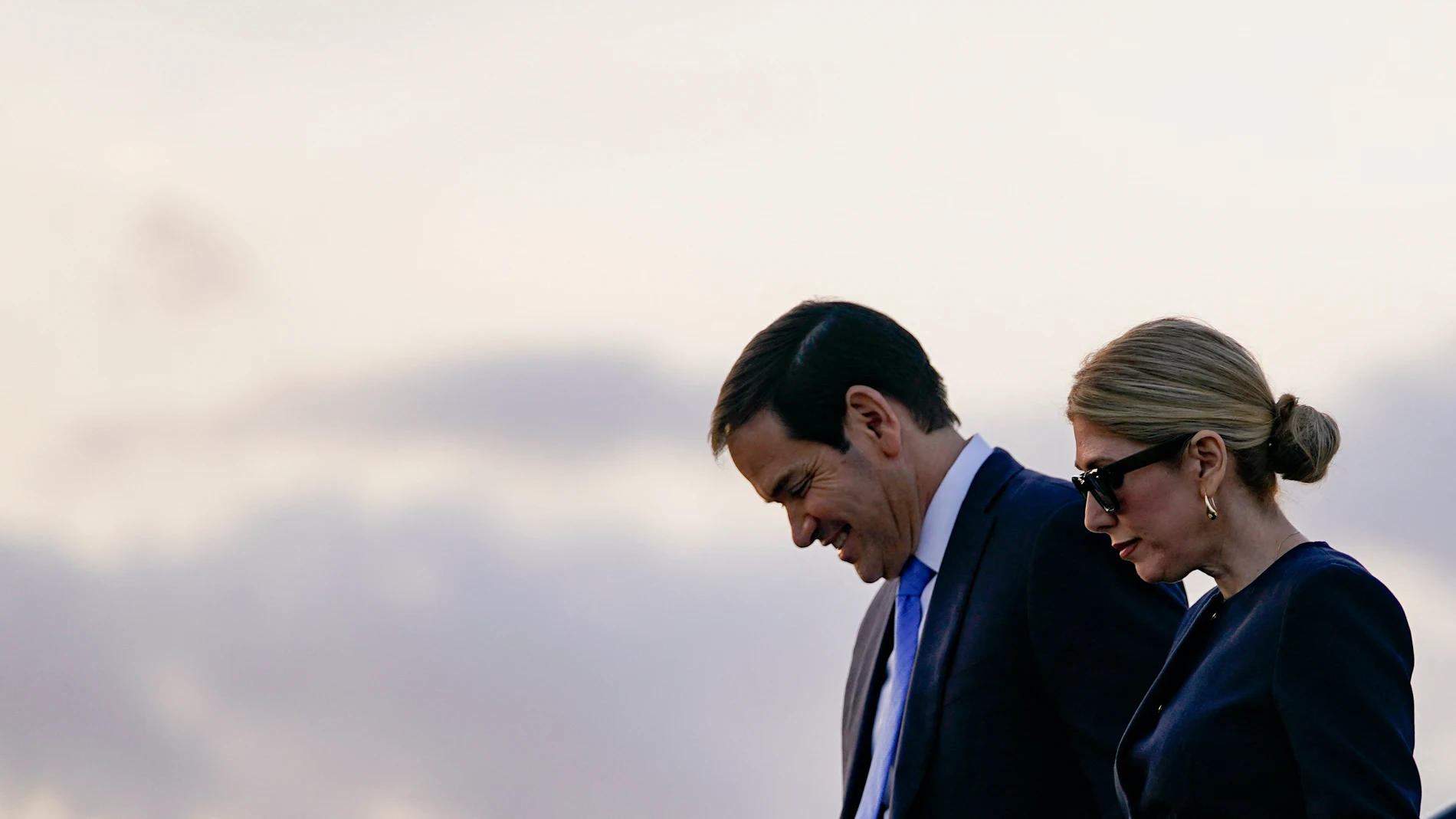 US Secretary of State Marco Rubio and his wife Jeanette Dousdebes disembark from an aircraft after landing at Stansted Airport, eastern England, on September 16, 2025. US President Donald Trump will also arrive in the UK late Tuesday for a second State Visit with his wife Melania, a rare privilege made at the invitation of King Charles III