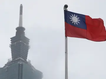 Taiwan Journalist National Security FILE - A Taiwan national flag flutters near the Taipei 101 building at the National Dr. Sun Yat-Sen Memorial Hall in Taipei, Taiwan, May 7, 2023. (AP Photo/Chiang Ying-ying, File)