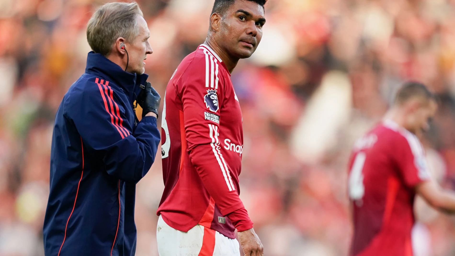 FILE - Manchester United's Casemiro, center, leaves the field with medics after sustaining an injury during the English Premier League soccer match between Manchester United and Brentford at Old Trafford stadium in Manchester, England, Oct. 19, 2024. (AP Photo/Dave Thompson, File)