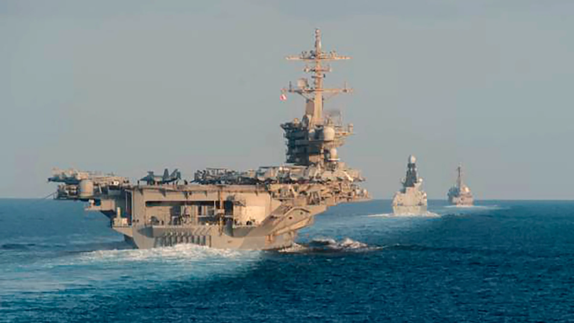 FILE - In this Nov. 19, 2019, photo made available by U.S. Navy, the aircraft carrier USS Abraham Lincoln, left, the air-defense destroyer HMS Defender and the guided-missile destroyer USS Farragut transit the Strait of Hormuz with the guided-missile cruiser USS Leyte Gulf. (Mass Communication Specialist 3rd Class Zachary Pearson/U.S. Navy via AP, File)