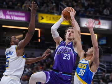 Utah Jazz forward Lauri Markkanen (23) shoots between Indiana Pacers forward Jarace Walker (5) and guard Ben Sheppard (26) during the second half of an NBA basketball game in Indianapolis, Tuesday, Feb. 3, 2026. (AP Photo/Michael Conroy)
