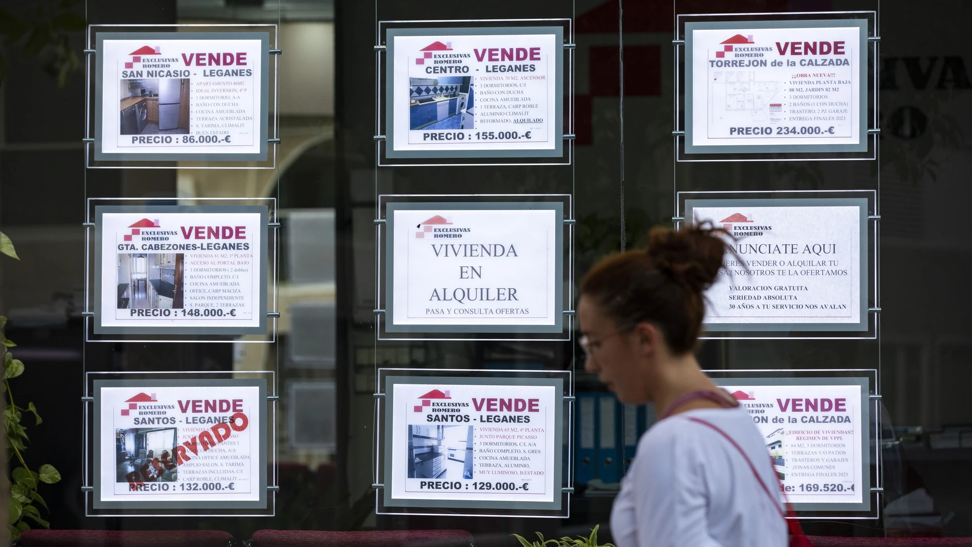 Imagen de anuncios de oferta de venta y alquiler de viviendas y locales en una inmobiliaria.