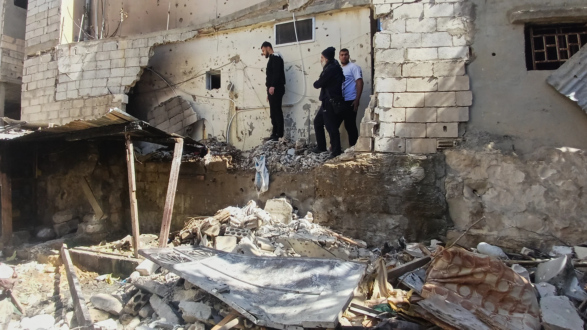 People check the damage at the site where two Hamas members were killed on Friday by an Israeli strike at Ein el-Hilweh Palestinian refugee camp, in the southern port city of Sidon, Lebanon, Saturday, Feb. 21, 2026. (AP Photo/Mohammed Zaatari)