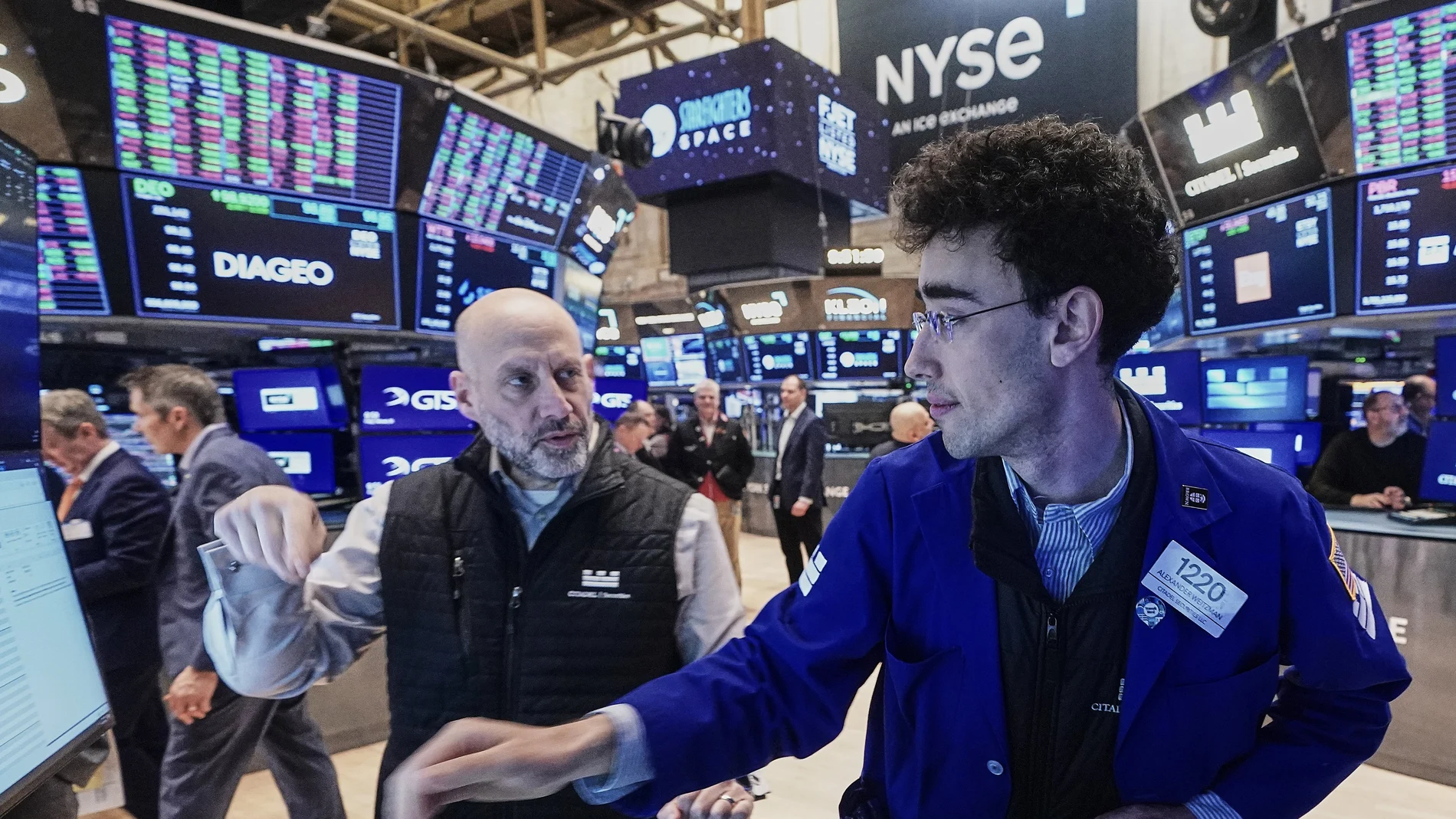 Specialists Meric Greenbaum, left, and Alex Weitzman work on the floor of the New York Stock Exchange, Friday, Feb. 20, 2026.