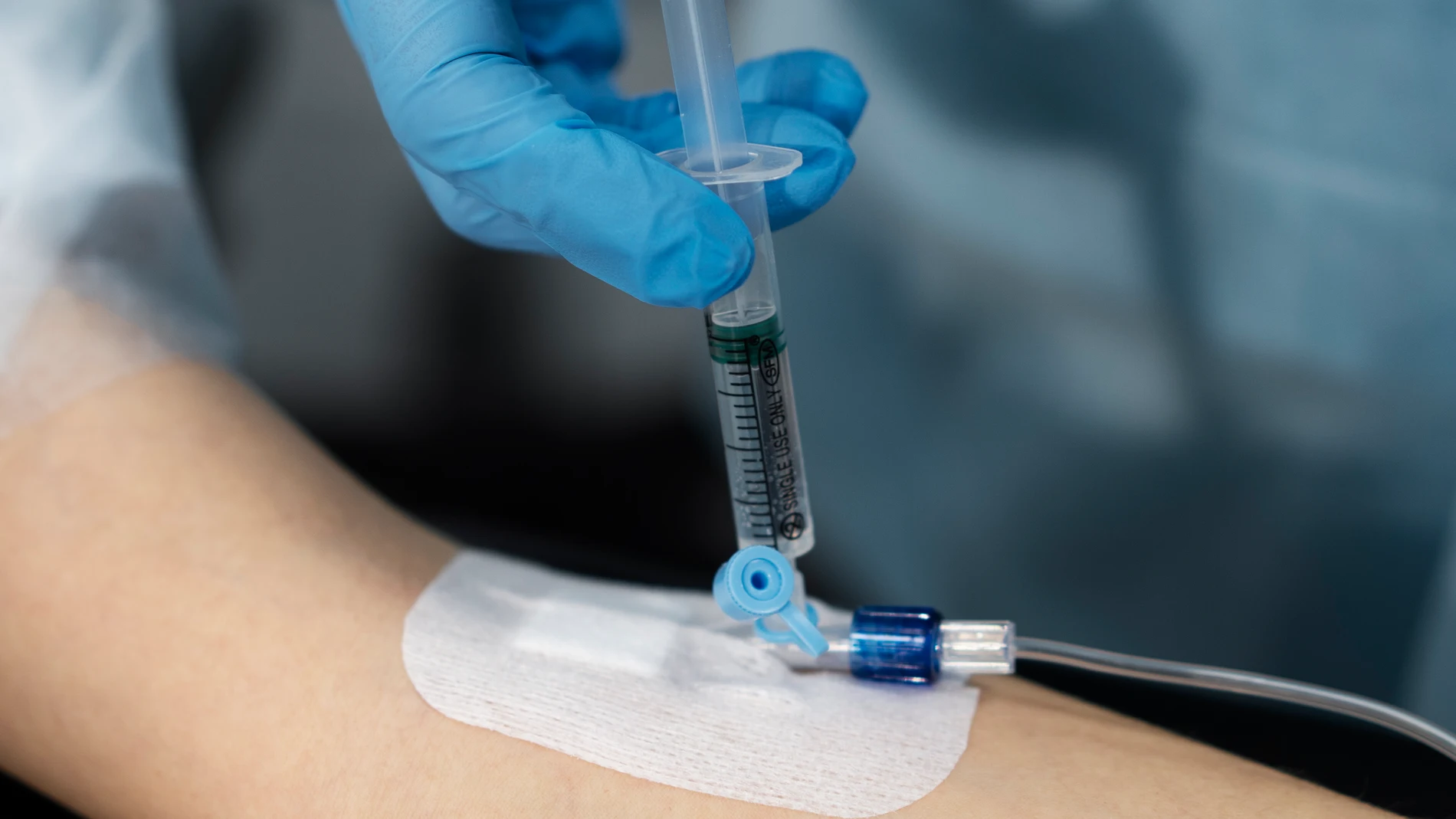 Enfermera utilizando un catéter, dispositivo sanitario en forma de tubo que se introduce en el cuerpo humano