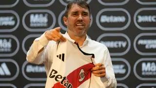 Argentina River Soccer Coach Eduardo Coudet holds up his River Plate jersey as he is presented as the club's new soccer coach in Buenos Aires, Argentina, Wednesday, March 4, 2026. (AP Photo/Gustavo Garello)