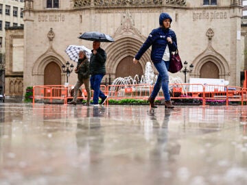 GRAFCVA2518. CASTELL&Oacute;N, 06/03/2026.- La Comunitat Valenciana afronta un fin de semana con la lluvia como gran protagonista, que ser&aacute; generalizada y podr&aacute; dejar incluso tormentas, mientras el ambiente seguir&aacute; siendo fresco y la cota de nieve se situar&aacute; entre los 1.400 y los 1.600 metros, seg&uacute;n el pron&oacute;stico de la Aemet. En la imagen varias personas caminan bajo la lluvia, este viernes, por las calles del centro de Castell&oacute;n. EFE/Andreu Esteban