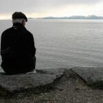 Un anciano sentado frente al mar