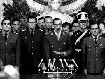  In this March 24, 1976 file photo, Gen. Jorge Rafael Videla, center, is sworn-in as president at the Buenos Aires Government House accompanied by Adm. Emilio Massera, second from left, and Brig. Orlando Agosti, second from right, members of the junta that overthrew President Isabel Peron. The former Argentine dictator died of natural causes Friday, May 17, 2013, while serving life sentences at the Marcos Paz prison for crimes against humanity. Videla took power in a 1976 coup and led a military junta that killed thousands of his fellow citizens in a dirty war to eliminate "subversives." He was 87. 