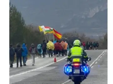 Un motorista escolta a un grupo de peregrinos Un motorista escolta a un grupo de peregrinos