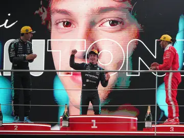 APTOPIX China F1 GP Auto Racing Race winner Mercedes driver Andrea Kimi Antonelli of Italy, center, celebrates on the podium with second placed Mercedes driver George Russell of Britain, left, and third placed Ferrari driver Lewis Hamilton of Britain after the Chinese Formula One Grand Prix race at the Shanghai International Circuit, in Shanghai, China, Sunday, March 15, 2026. (AP Photo/Andy Wong)