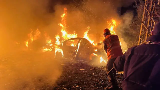 Lebanon Israel Iran War Rescue workers battle flames engulfing vehicles at the site of an Israeli airstrike in Beirut, Lebanon, Wednesday, April 1, 2026. (AP Photo/Hussein Malla)