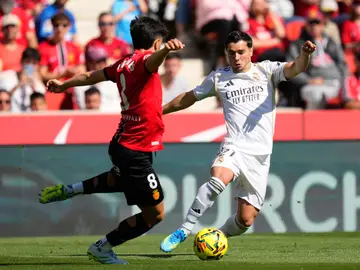 Mallorca-Real Madrid Mallorca's Manu Morlanes, left, and Real Madrid's Brahim Diaz fight for the ball during a La Liga soccer match between Mallorca and Real Madrid in Palma de Mallorca, Spain, Saturday, April 4, 2026. (AP Photo/Jose Breton)