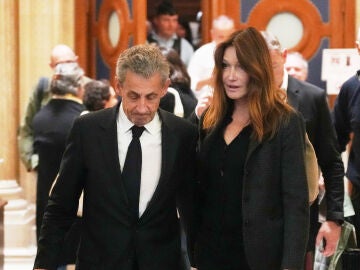Former French President Nicolas Sarkozy and his wife Carla Bruni-Sarkozy leave the appeals courthouse in Paris, France, Tuesday, April 7, 2026, during his trial appealing a conviction involving illegal campaign funds from Libya. (AP Photo/Thibault Camus)